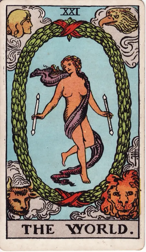 The World, from the 1909 Rider-Waite-Smith deck: a dancing figure wrapped in a violet sash floats inside a laurel wreath tied with red ribbons, a wand in each hand, with an angel, an eagle, a bull and a lion in the four corners.