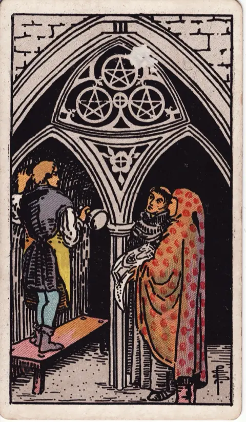 Three of Pentacles, from the 1909 Rider-Waite-Smith deck: a stonemason stands on a bench carving a church arch marked with three pentacles, while a monk and a man holding the plans look on.