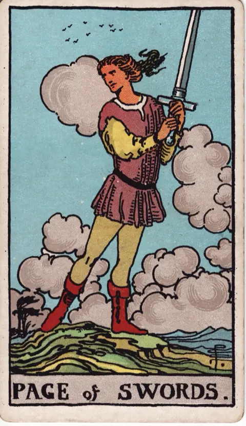 Page of Swords, from the 1909 Rider-Waite-Smith deck: a young man stands on a hill holding a raised sword in both hands, glancing to one side, wind-blown clouds and birds behind him.