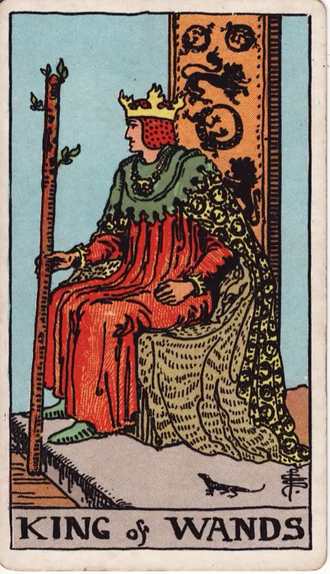 King of Wands, from the 1909 Rider-Waite-Smith deck: a king sits on a throne decorated with lions and salamanders, holding a sprouting wand, a small salamander on the ground beside him.